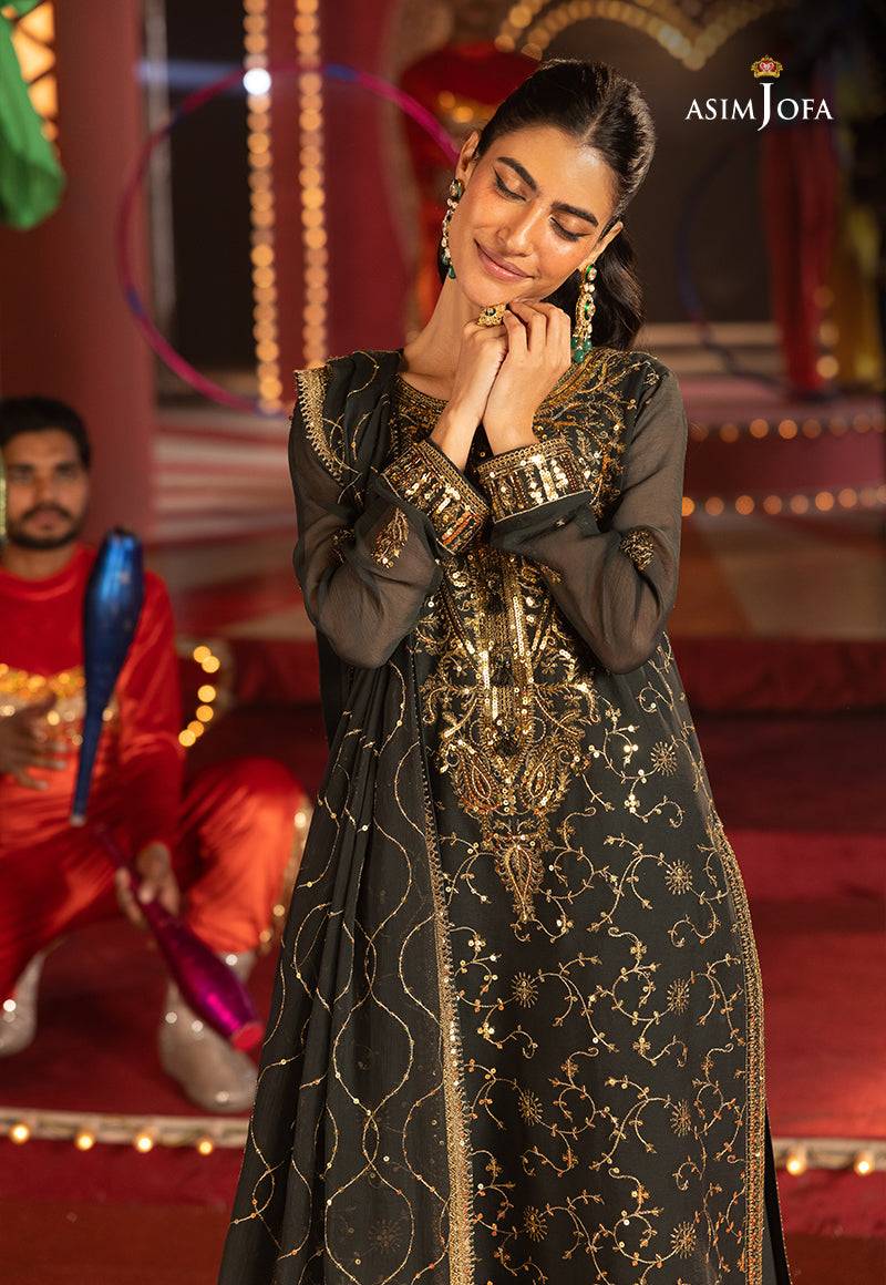 Model in deep green outfit from Asim Jofa's Festive Collection 25, showcasing intricate gold embroidery.